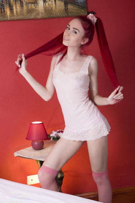 Hot skinny redhead Ariel poses naked on her bed in red fishnet stockings 78243801
