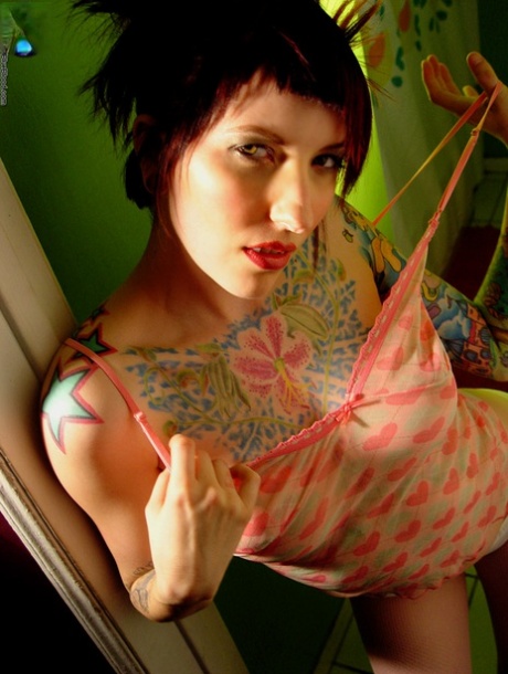 Tattooed redhead Erica uncovers her great tits during solo action 13165379