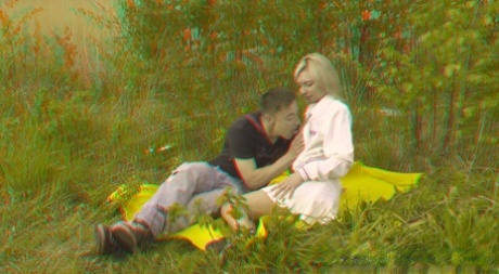 Blonde girl has sex with a boy on a blanket near some some saplings 39611354