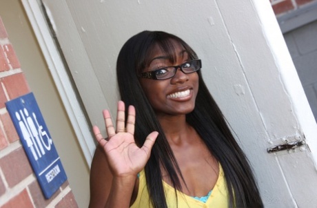 Black chick Ana Foxxx keeps her glasses on during gloryhole sex in a washroom